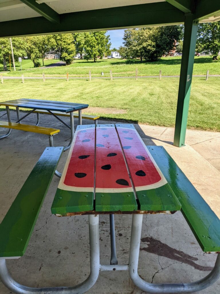 Picnic tables under the shelter in Mount Blanchard’s Island Park (Photo credit: Deborah Fallows)