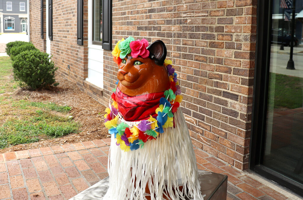 The bank vault (left) remains, now serving as a space for teens. The Lancaster County Council of the Arts launched a creative placemaking initiative that led to statues of dogs and cats (like the one seen here outside of the library) throughout the county. Photos by Michelle Ellia.