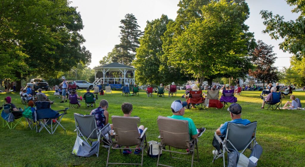 Image of summer concert on gazebo with residents in chairs listening in Pittsfield Maine, a Community Heart & Soul town