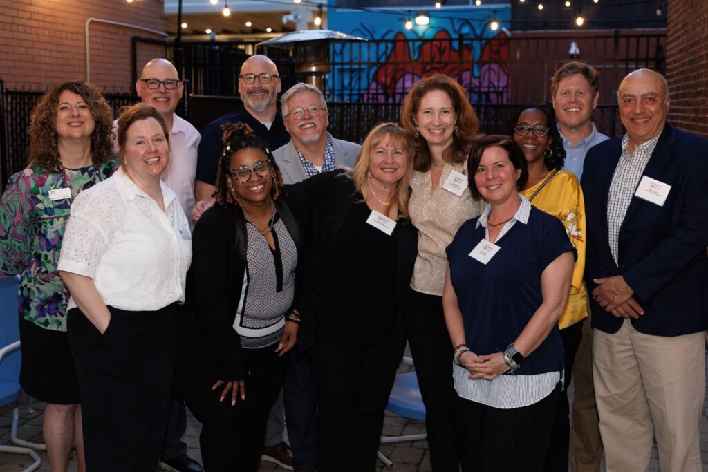 Members of the PA Humanities team, led by Executive Director Laurie Zierer (far left) and members of the Community Heart & Soul team, led by Mark Sherman (far right) pose for a photo during the kick-off reception in Harrisburg, Pennsylvania, celebrating the two organization’s 10-year partnership. Photo by Rustbelt Mayberry Photography.