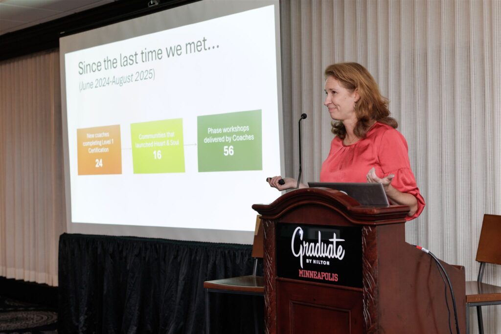 Joan Wagner, Senior Program Associate, showcasing 2024 and 2025's combined statistics on a slideshow.