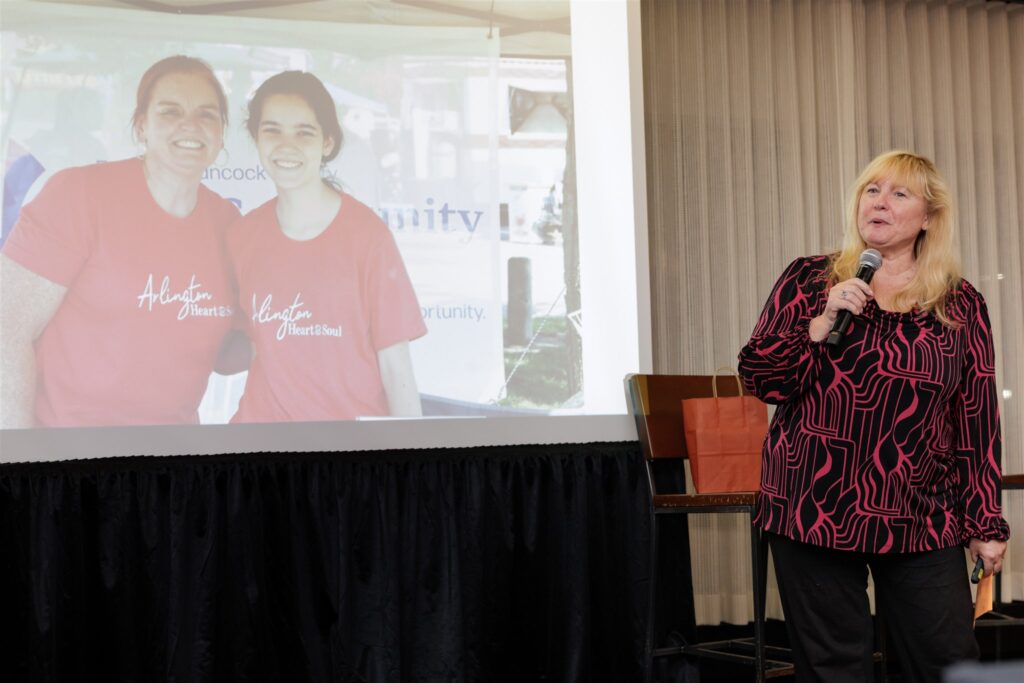 Leanne Tingay standing in front of an image of Cassie Turner, sharing appreciation for her efforts.