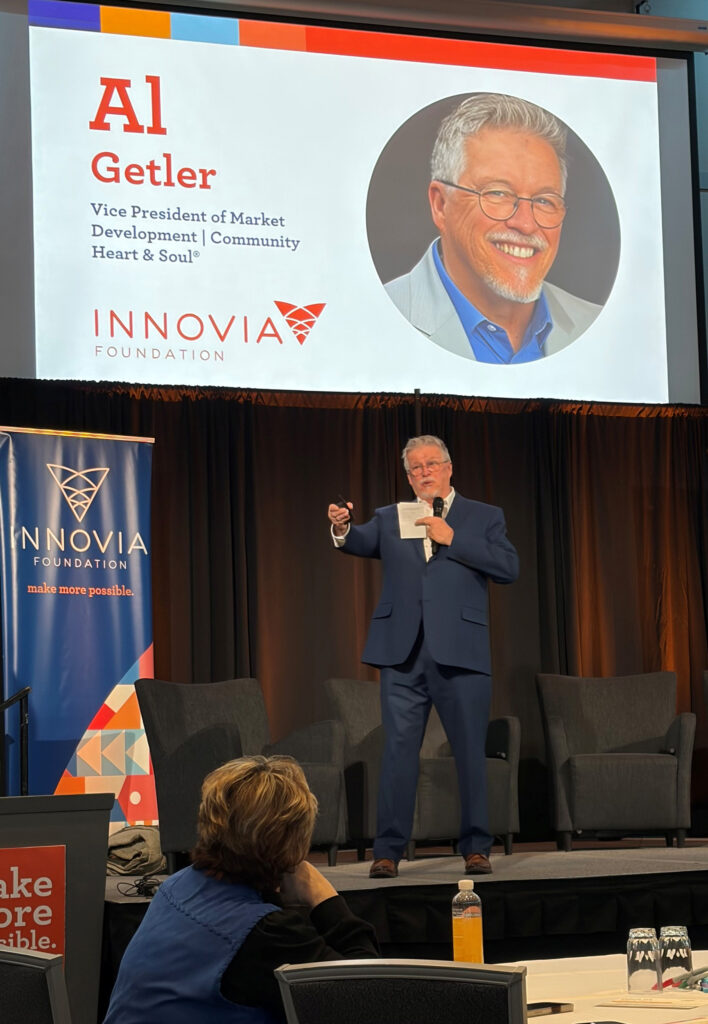 Picture of Community Heart & Soul VP Market Development, Al Getler, presenting on stage at the Innovia Foundation Summit