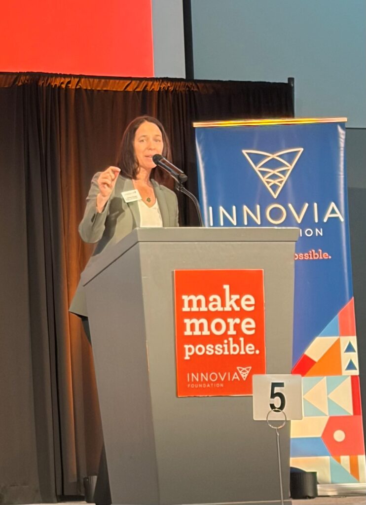 Picture of Shelly O'Quinn, Innovia Foudation CEO, at the podium presenting at the Innovia Foundation Summit