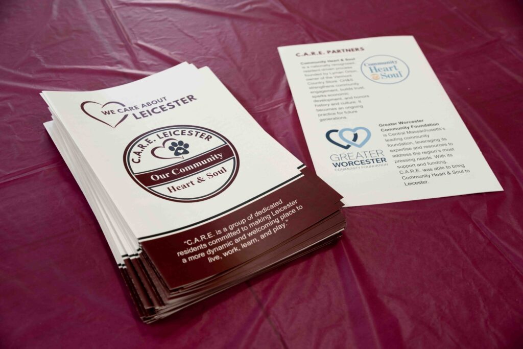 Pamphlets provided to residents from C.A.R.E. Leicester highlighting their mission, accomplishments, and supporting partners. Photo credit: Summit and Spruce.